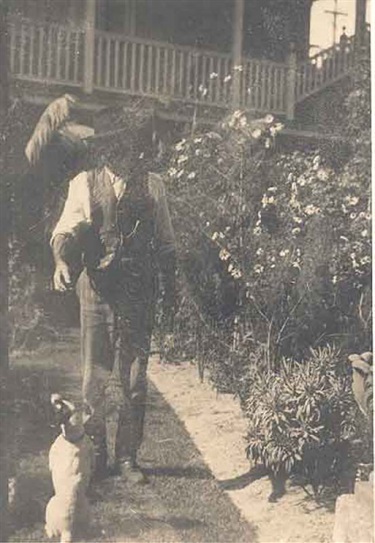 The gardener with a dog in the garden of St Brigids, Double Bay, ca. 1913-1916. Woollahra Libraries Digital Archive, pf002118.