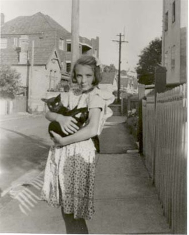 Young girl nursing a cat, The Retreat (laneway), Double Bay, 1940s-1950s. Woollahra Libraries Digital Archive, pf002764.