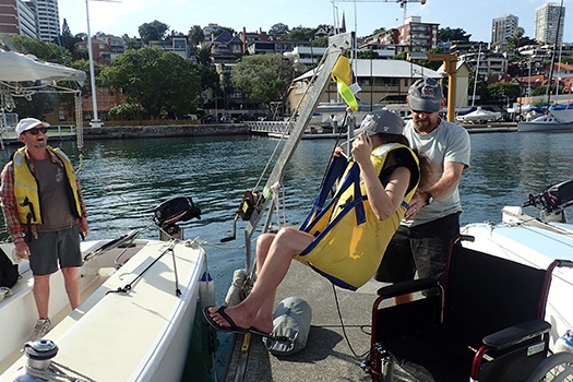 Sailability team helping people on board yacht