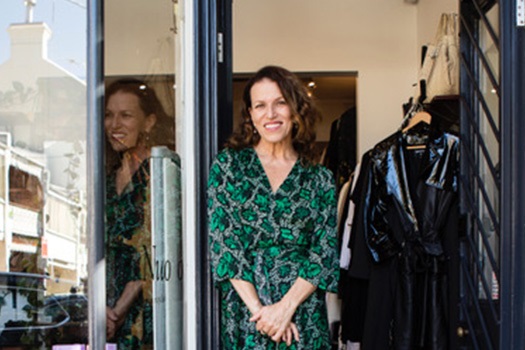 Woman standing in front of shop