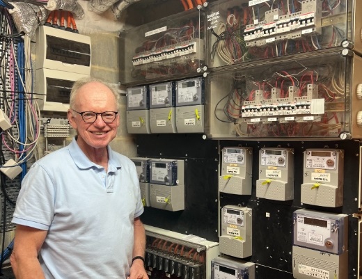 man in meter room of apartment block